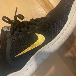Women's gold/black nikes